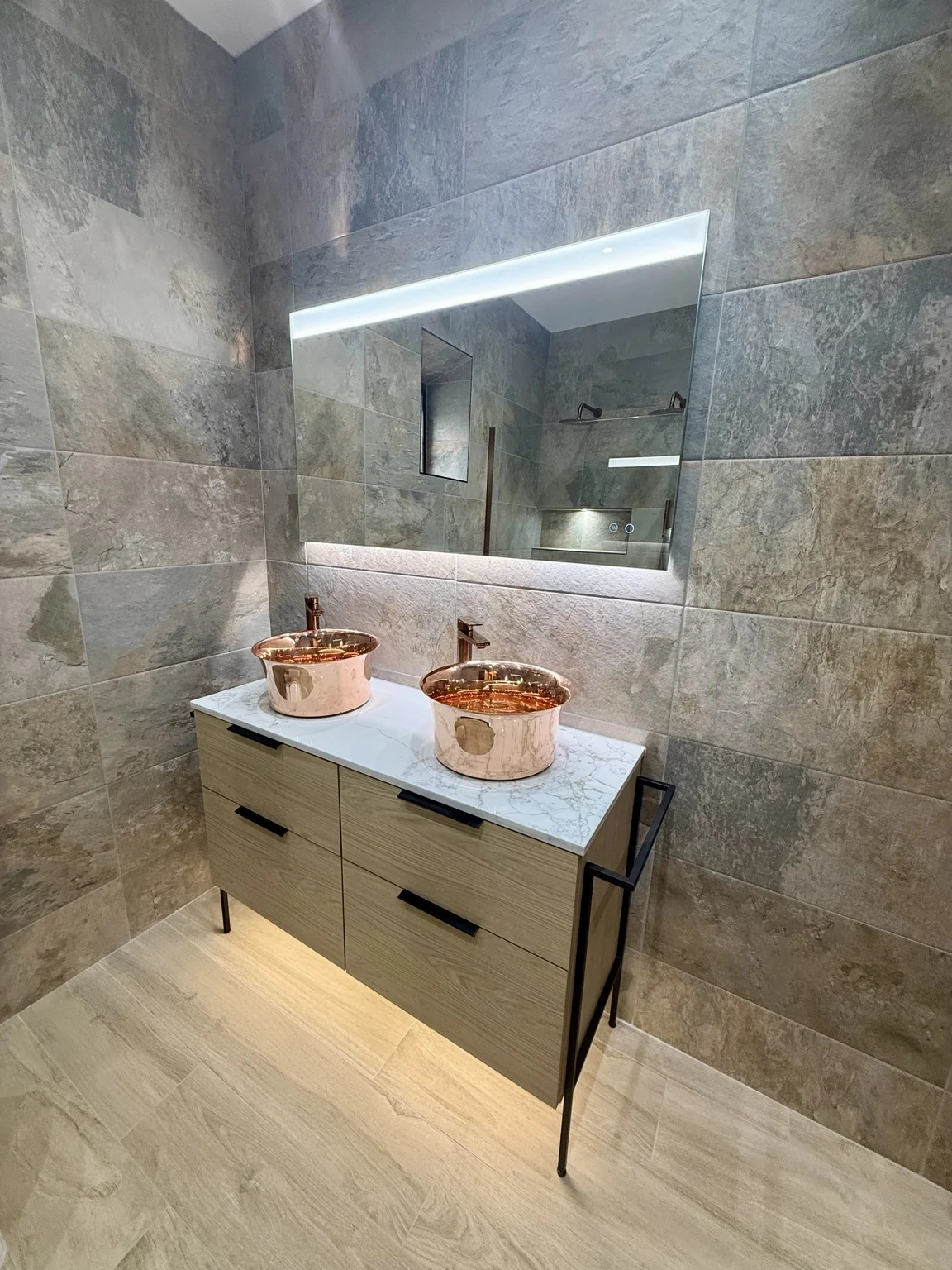 Twin copper basins and oak furniture in a bathroom completed by DDI