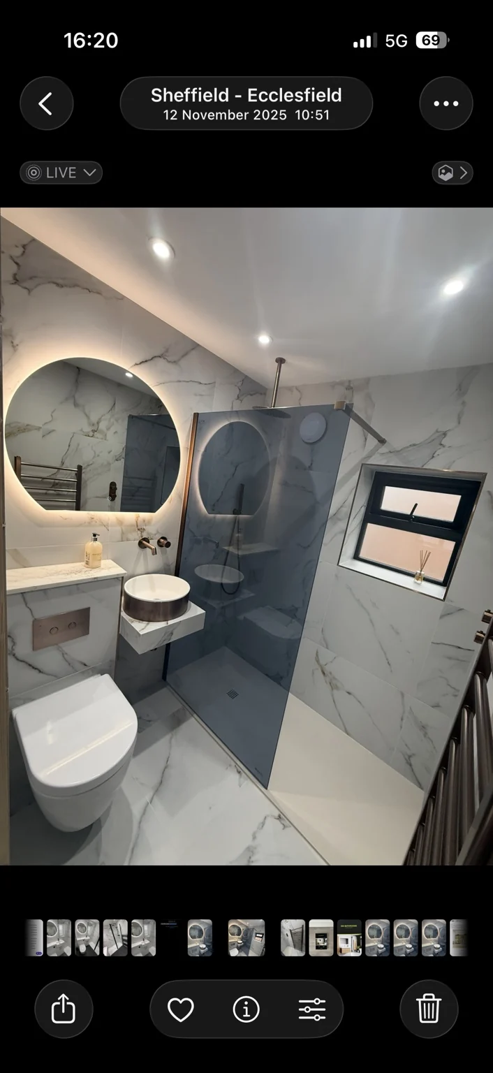 Marble shower room with smoked glass screen and wall-hung basin — completed DDI bathroom